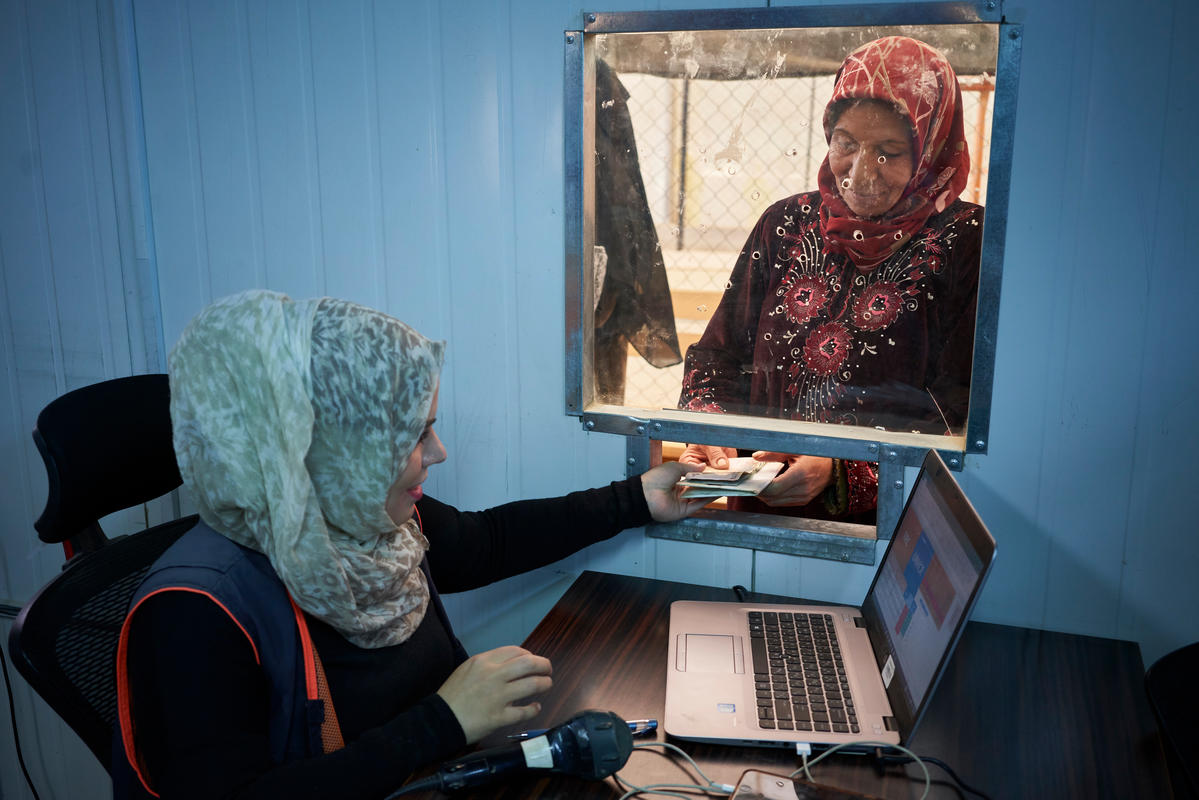 Jordan. Syrian refugees queue for winter cash assistance at Zaatari refugee camp