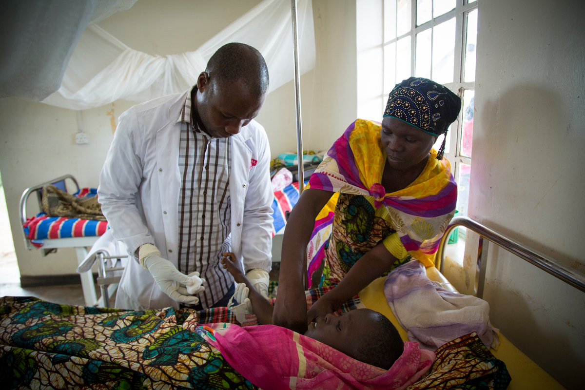 Uganda. Cancer-stricken refugee nurse cares for the sick