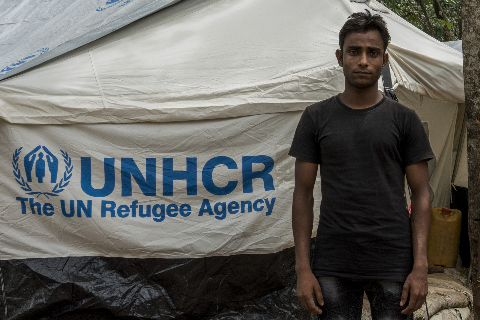 Mohammad Rafique, 20, a Rohingya refugee who fled Myanmar 40 days ago stands outside his tent in the UNHCR Transit Camp near Kutupalong refugee camp in Bangladesh on June 29th, 2018.