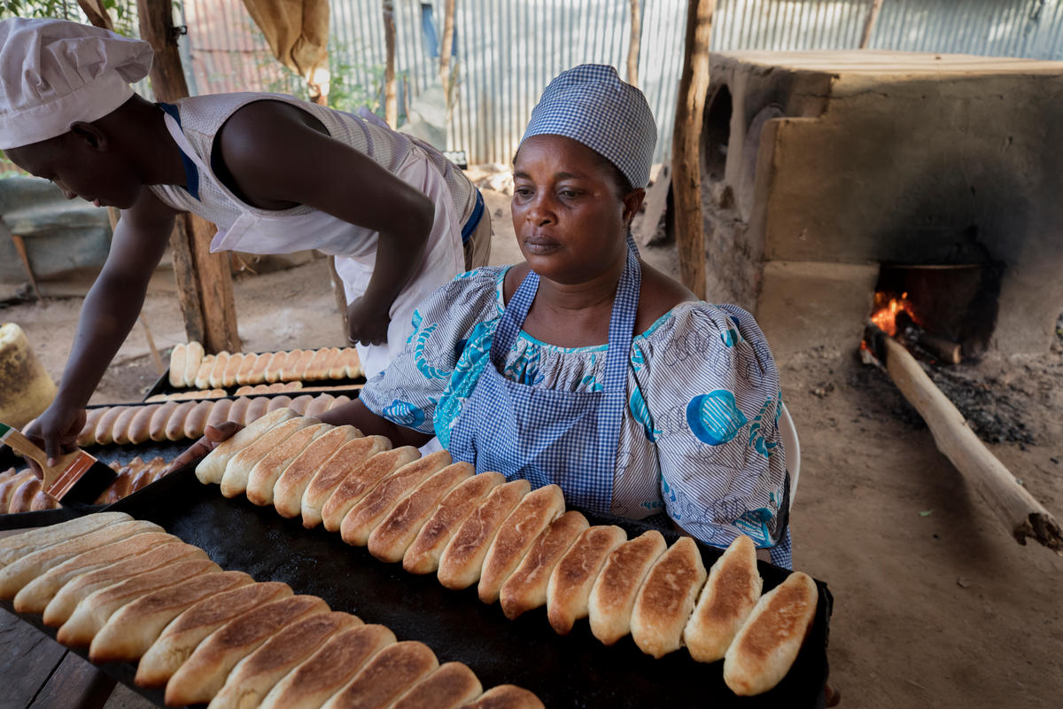 Mama Safi Kisasa, a refugee and small business owner, makes fresh bread with family members.