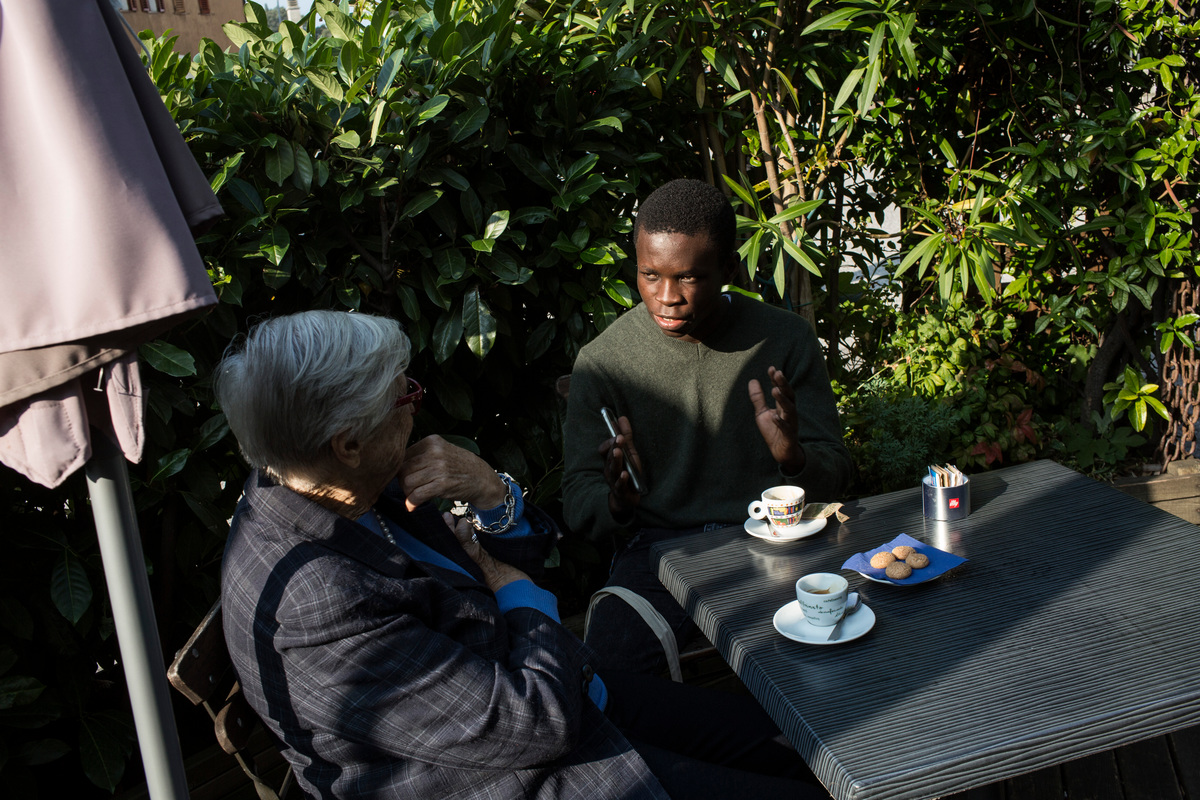 Italy. Emmanuel talks in a cafè with Anna Illy, who donated him the scholarship to Adriatic College in Duino, near Trieste