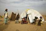 A refugee family from Darfur and their makeshift shelter in eastern Ch...