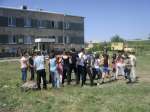 Young refugees from Iraq play outside the new residential block in Dar...
