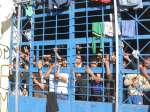 A group of young detainees stare at visitors to the crowded centre at ...