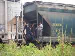 A group of young people hop a freight train in southern Mexico, hoping...