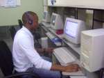 A young African uses one of the computers at the internet centre run b...