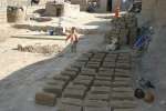 Mud bricks dry on the ground in the Pul-i-Charkhi neighbourhood. Famil...