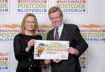 Imme Rog, chief executive officer of Dutch Charity Lotteries, hands a ...