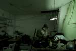 A young Afghan works hard in tough conditions in a small factory in Is...