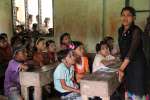 Rozeya teaches a classroom of students at a middle school in Myanmar's...