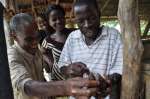 Ivorian refugee Sardia explains how to prepare a snail for eating.