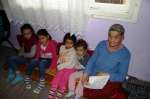 Arsen's mother sits with his children in their house in Gracanica, Kos...