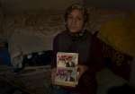 Leilah holds a photo album, the most important thing she managed to br...