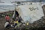 Congolese children play outside a crude shelter in Mugunga III camp. P...