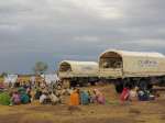 Refugees in Tissi wait to board trucks that will take them to the Ab G...