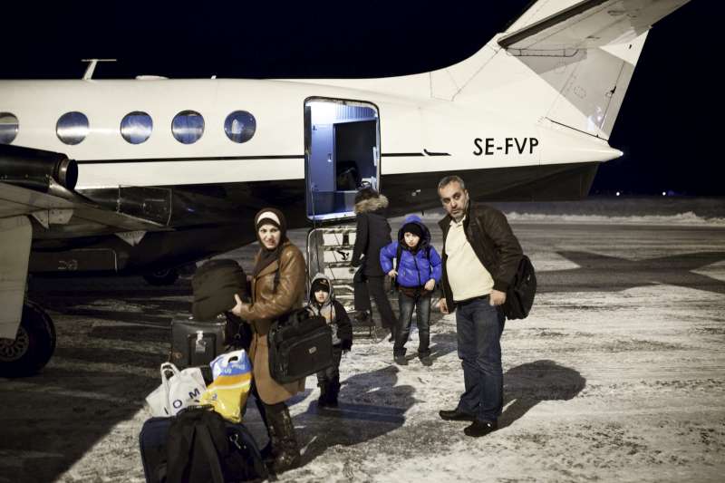 After hearing about Mahmoud's traumatic experience, the Swedish government accepted the boy and his family for resettlement. Here they are seen disembarking on a snowy January night from a passenger plane at their final destination, the small town of Torsby in south-west Sweden.