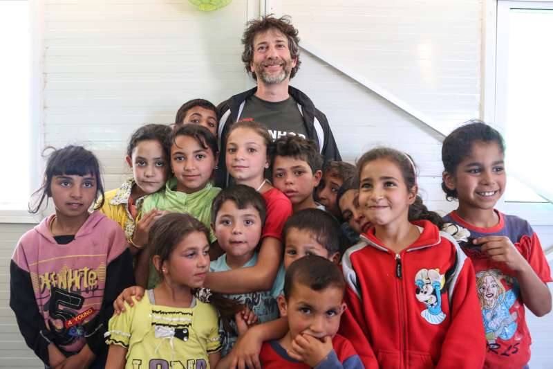 Image result for UK writer Neil Gaiman with refugee children