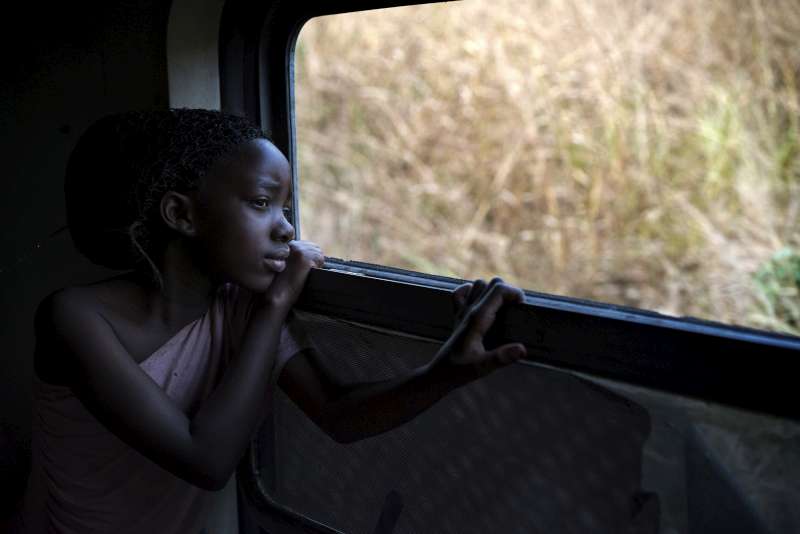 Faria takes in the sights as the train rushes towards Kimpese and she heads towards a new life in Angola, land of her forebears. 