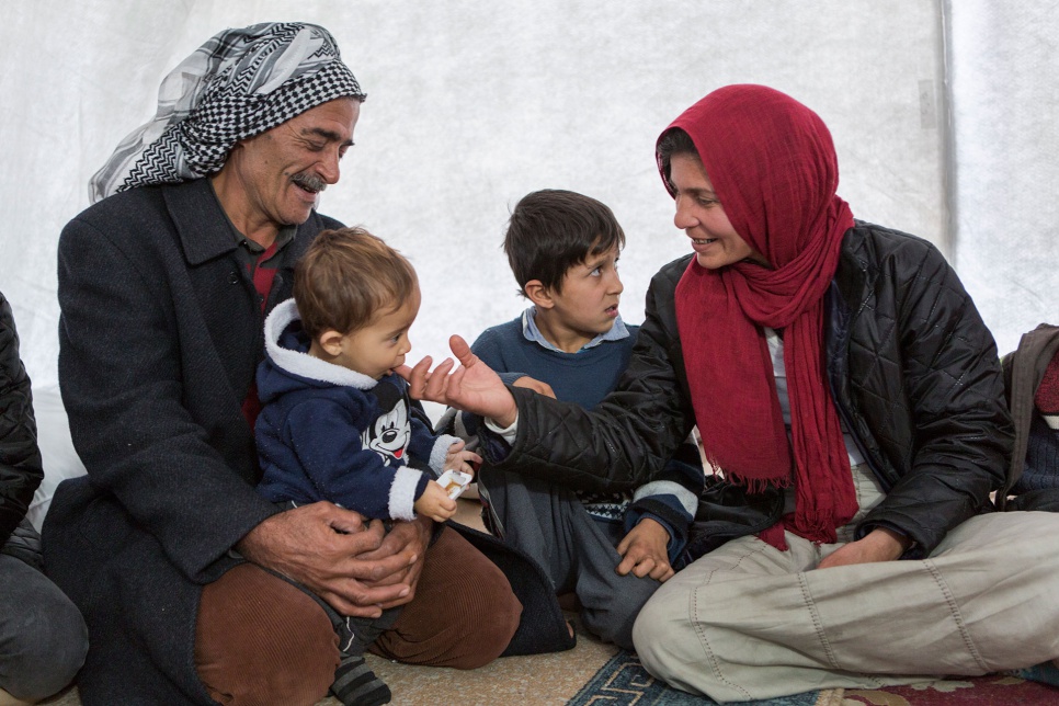 Wazzam and Ayesha play with their youngest child inside their new tent in Suruc camp in Turkey.