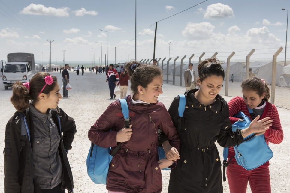 Ivra (second from left) walks with friends on the way back to her family's tent after school in Suruç camp.
