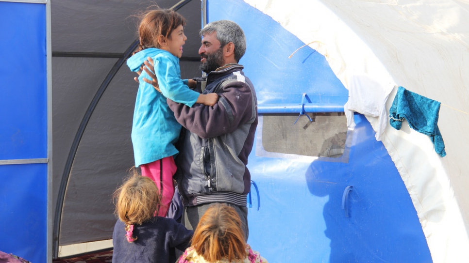 "My smile helped me overcome many difficulties in Mosul," says father-of-six Mahmoud Ahmad, 35, as he and his family enjoy the freedom that greeted them on arriving at a camp for displaced Iraqis.