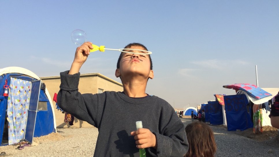 A young boy blows bubbles at a camp for internally displaced Iraqis near the village of Hasansham, 30 kilometres from Mosul.