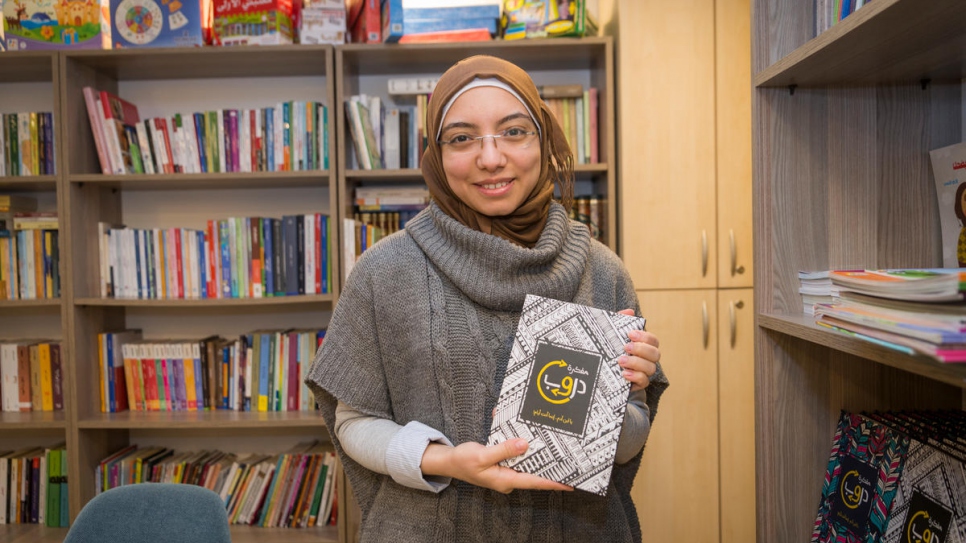 Syrian refugee Nada holds a creative diary that she designed and published, which she sells in her book cafe in Istanbul where other Syrian refugees come to read, buy and borrow Arabic books.
