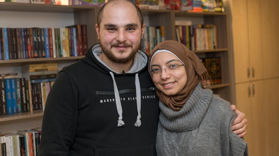 Nada, 27, and her fiancé Mohammad, 25, stand inside a book café they run together in Istanbul. Both originally from Syria, they met in Istanbul after Nada started a lending library offering Arabic books to the city's Syrian refugees.