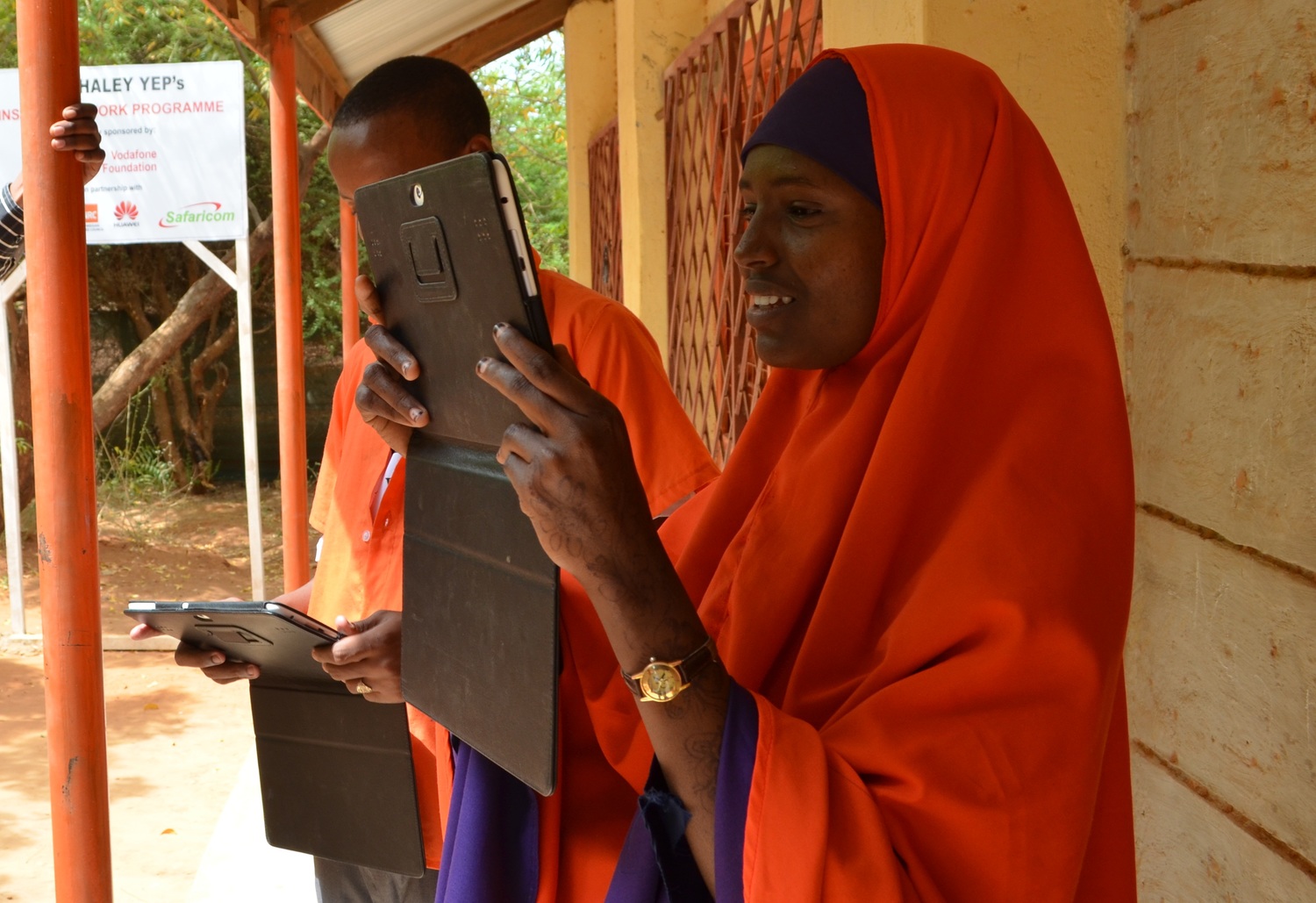 Kenya. Refugee students use tablets during secretarial course