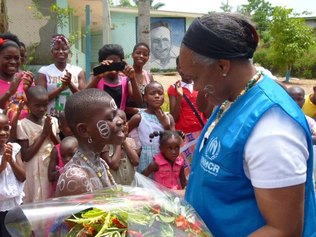 Barbara Hendricks is greeted with flowers by a child.