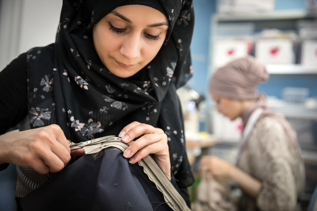 Germany. Refugee women got a job as a seamstress in a Frankfurt fashion workshop.