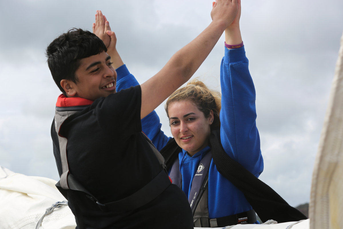 Ireland. A Syrian Asylum Seeker and an Irish guy enjoying a moment on a sail training vessel off the coast of West Cork