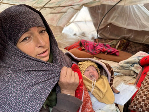 An earthquake-affected Afghan woman in a tent