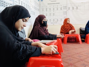 A visually impaired woman using brail 