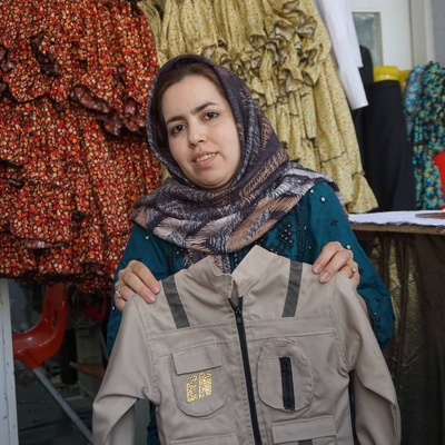 Asifa, a UNHCR beneficiary showing products