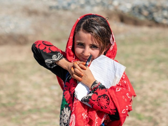 An Afghan girl with her school notebook