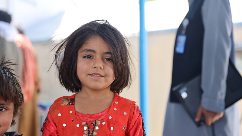 An Afghan child in UNHCR's encashment center