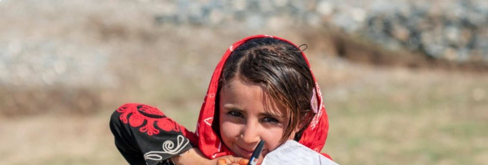 An Afghan girl with her school notebook