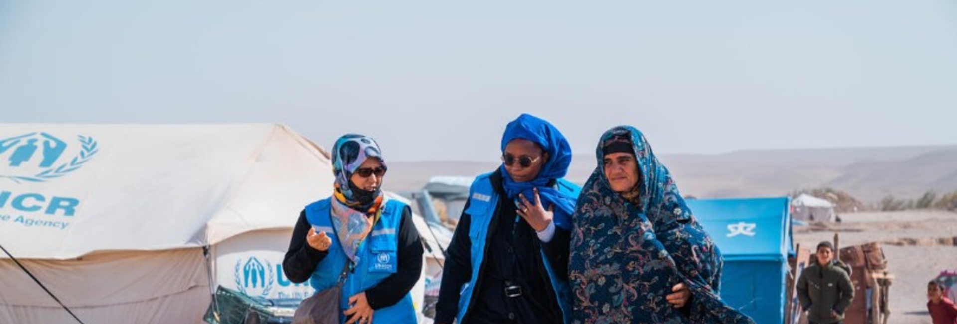 UNHCR staff in front of emergency tents for the earthquake affected families