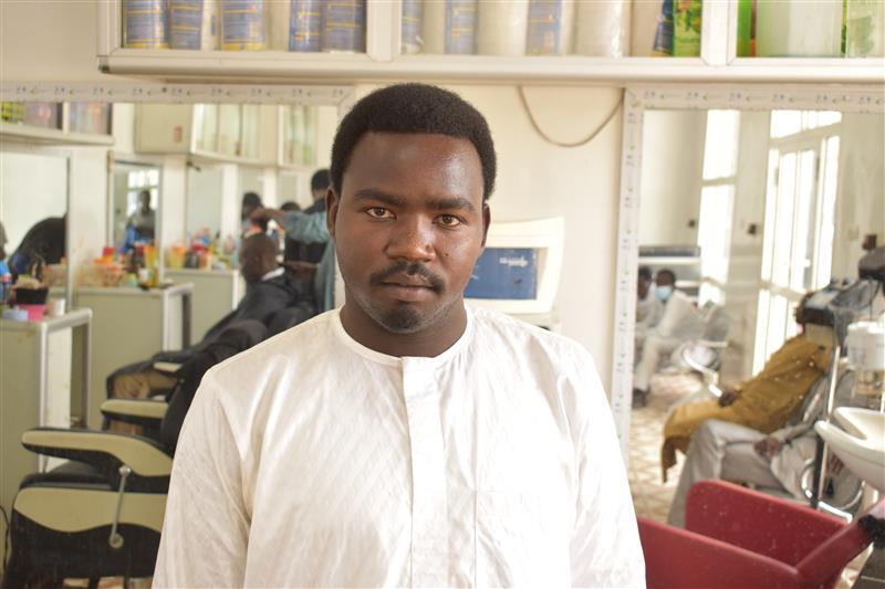 Chad. Zanoun Mahamat Bahr, stands in one of the barbershops he owns in Abeche