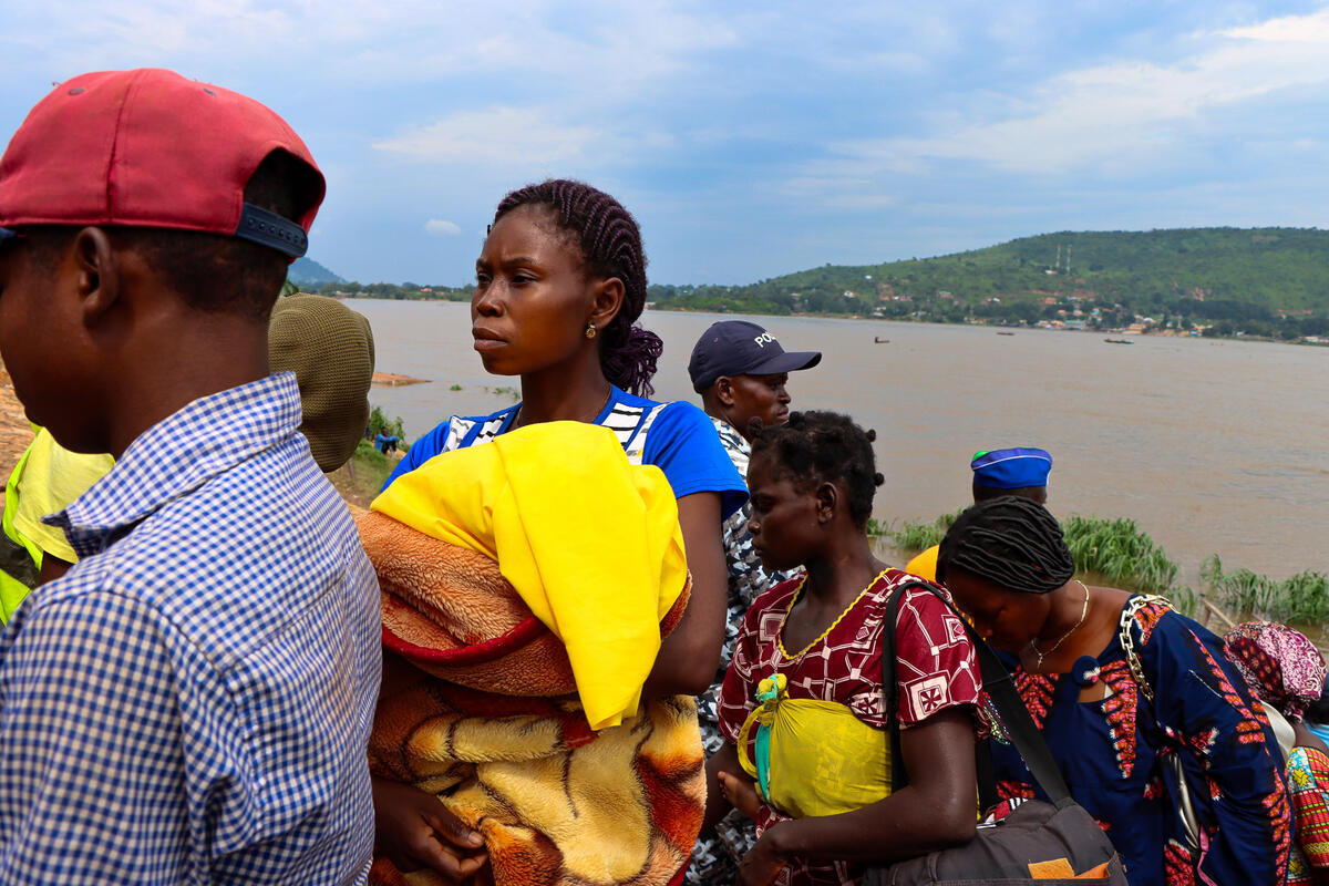 Central African Republic. As the river convoy arrives at Bangui's Port Amont, Micheline disembarks with several other Central Africans returnees