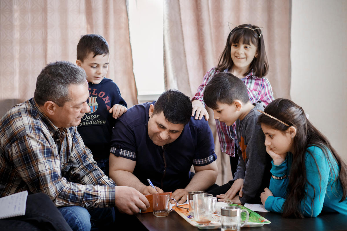 Belarus. A family of resettled Syrian refugee spends Sunday together in their new home in Gomel