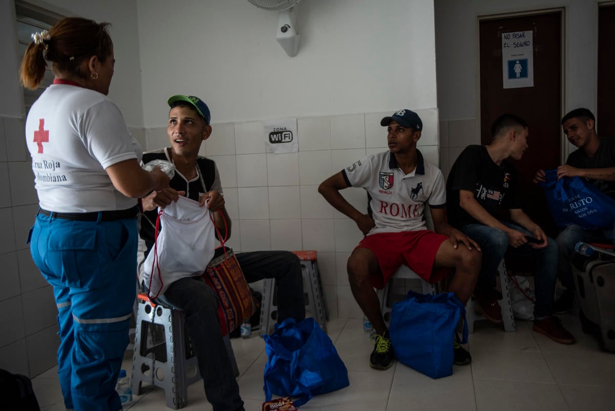Colombia. Red Cross volunteer talks with migrants