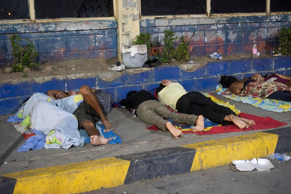 Colombia. Venezuelan migrants sleep in front of the bus terminal in Maicao