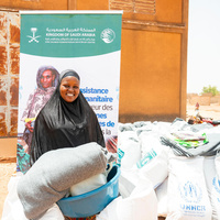 Burkina Faso. Odile Ouédraogo, an Internally Displaced Person (IDP), receives a core relief kit in the Yaadga region