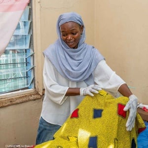 Pang Ismail attending to a patient at the community rehabilitation center.