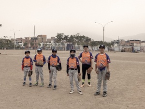 Six boys in baseball uniforms attend a traning session