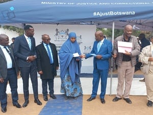 Refugees receiving citizenship certificates in Dukwi refugee settlement in Botswana during a handover ceremony with government officials.