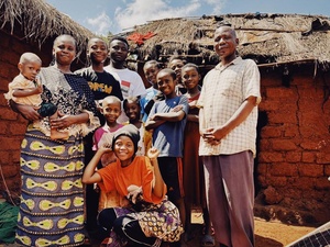 Tanzania. The Ekyamba family stand in front of their shelter in Nyarugusu refugee camp as they wait for confirmation of their final departure date to the U.S.