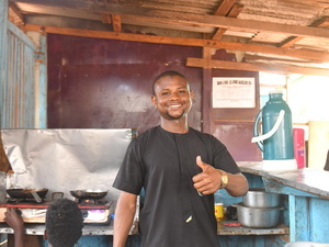 Cameroon. Amadou Haphizou CAR refugee stands in front of his cafe restaurant ready to serve his clients.